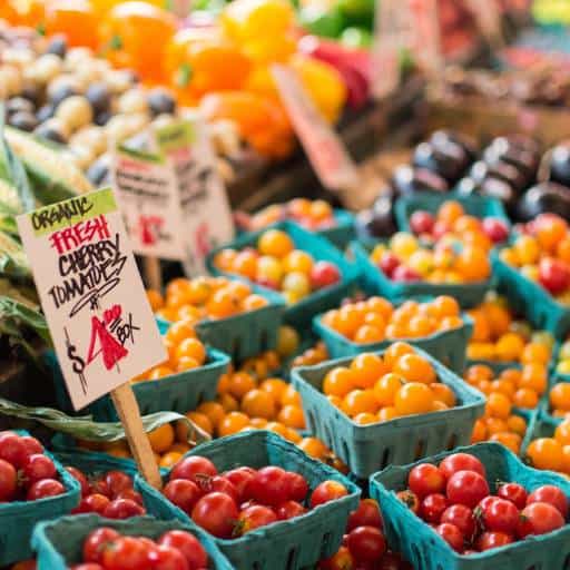 Fresh cherry tomatoes in baskets at a local market.